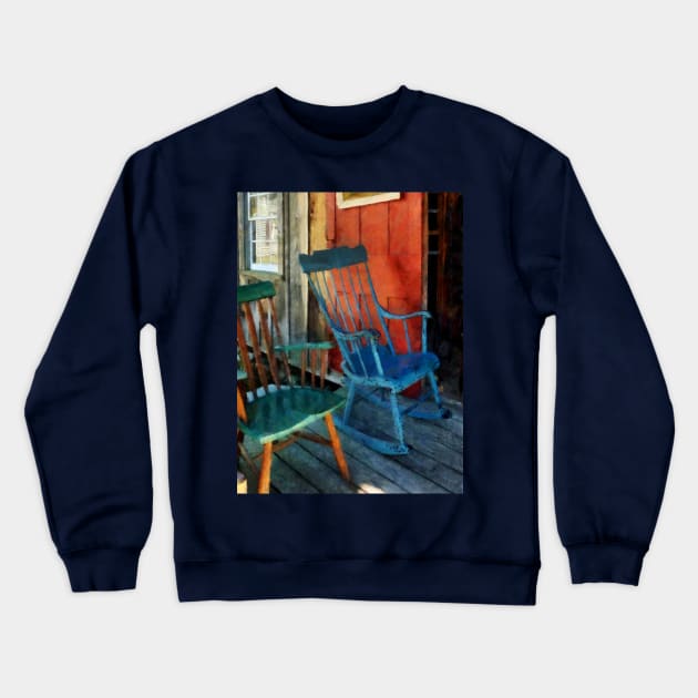 Blue and Green Rocking Chairs Against Red Door Crewneck Sweatshirt by SusanSavad